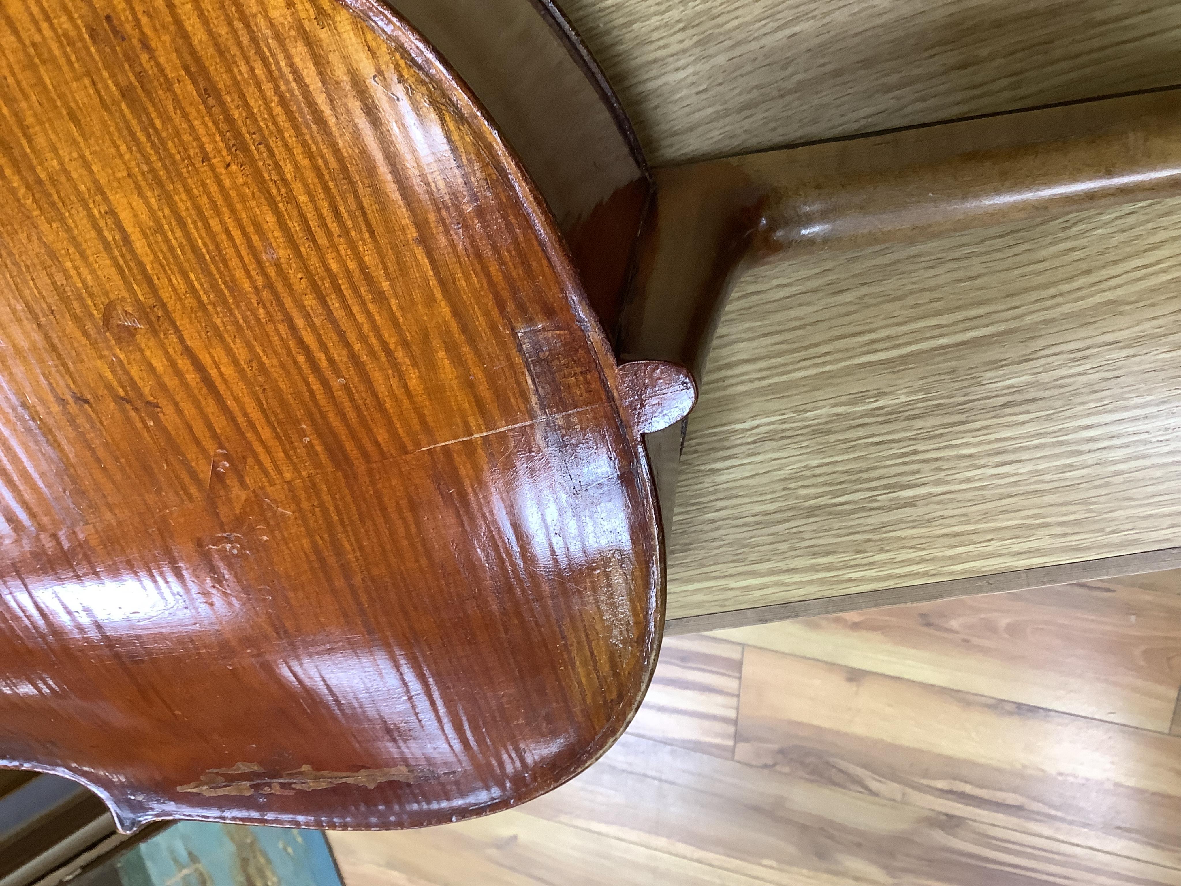 A cased late 19th century German? cello, body length 75cm, together with two bows. Condition - fair to good.